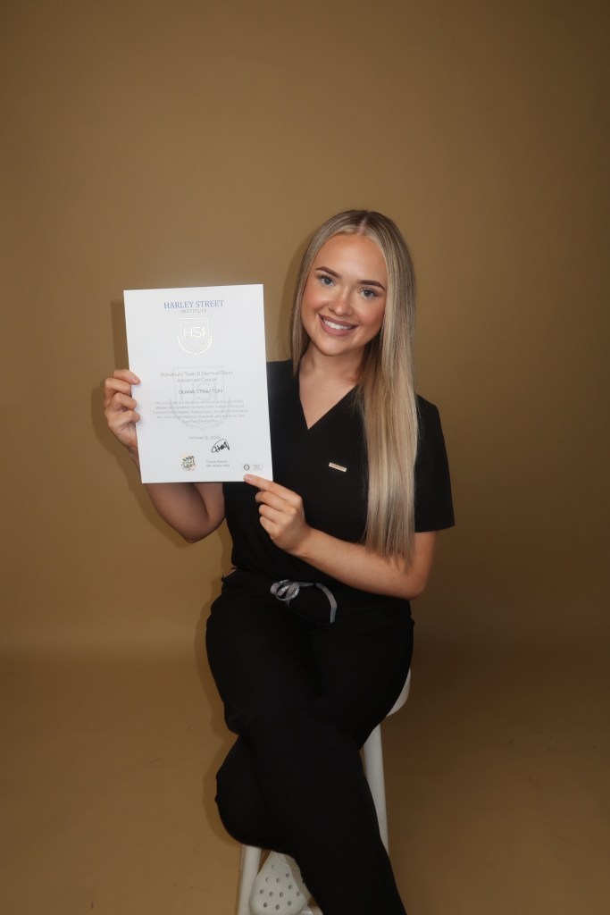 Olivia Stratton holding a certificate from Harley Street